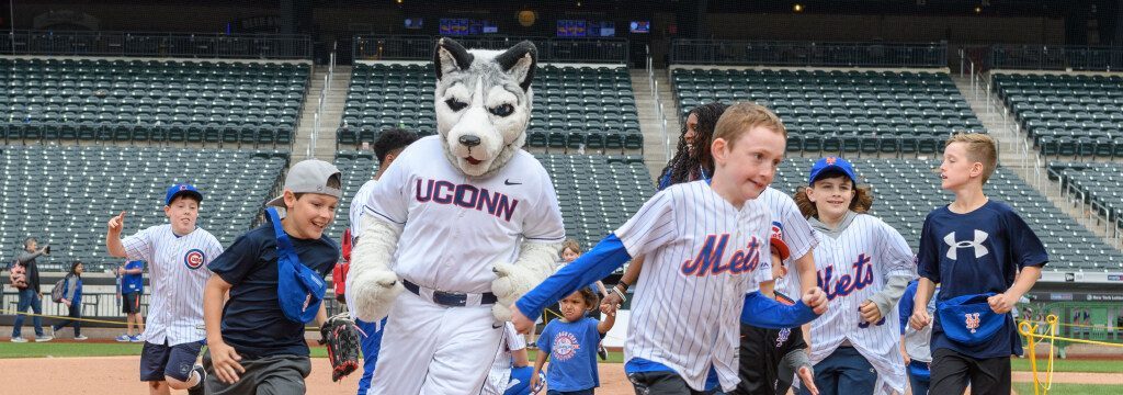 jonathan the husky mascot playing baseball with the community